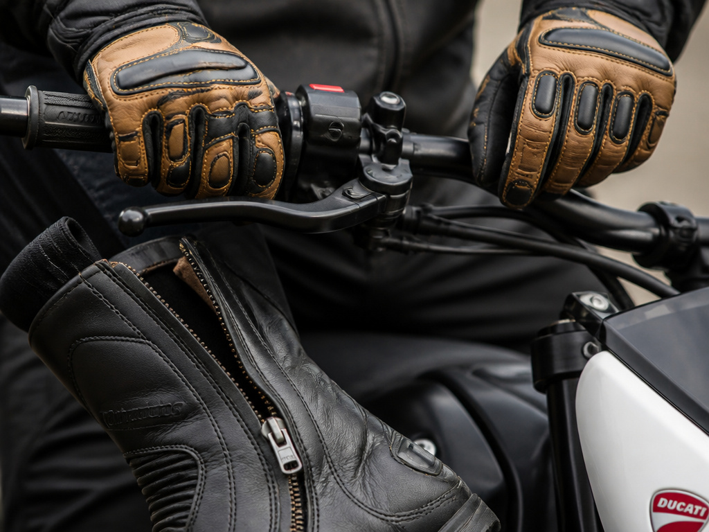 Close-up of ill-fitting and proper motorcycle gloves for long-fingered riders.