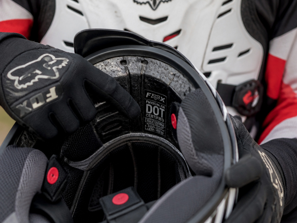 Close-up of motocross helmet safety certification label and interior construction.
